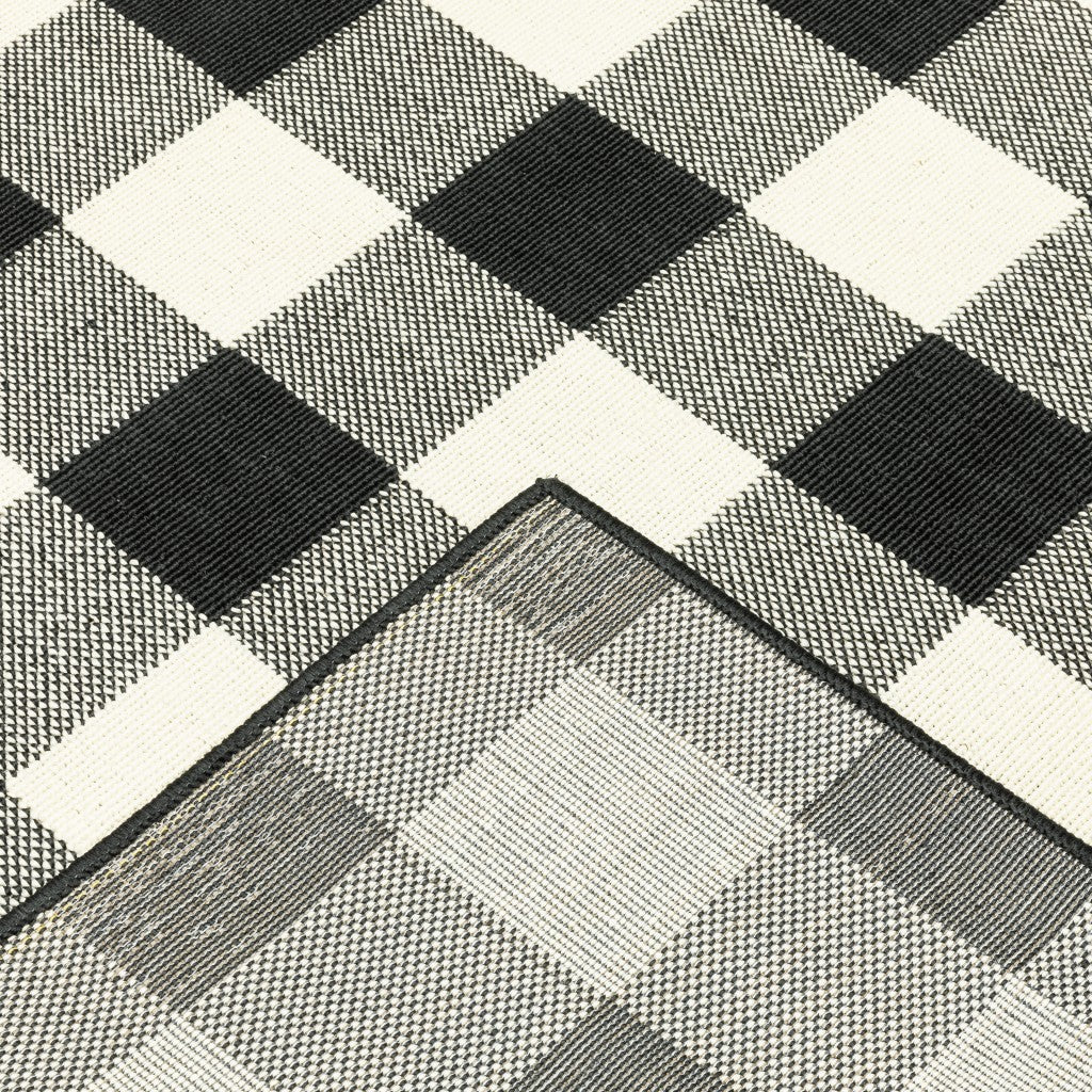 HomeRoots Polypropylene 5’x8’ Black and Ivory Gingham Indoor Outdoor Area Rug