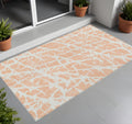 3' X 5' Peach And Ivory Abstract Washable Non Skid Indoor Outdoor Area Rug