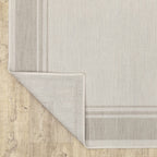 HomeRoots Polypropylene 8’x10’ Ivory and Gray Bordered Indoor Outdoor Area Rug