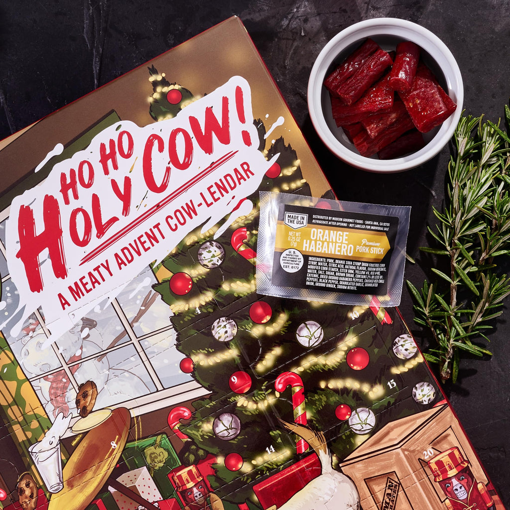 Man Crates Jerky Advent Calendar 2024 - 25 Beef Jerky Bites in Red with "Ho-Ho-Holy Cow" Artwork - Flavors: Orange Habanero, Rootbeer